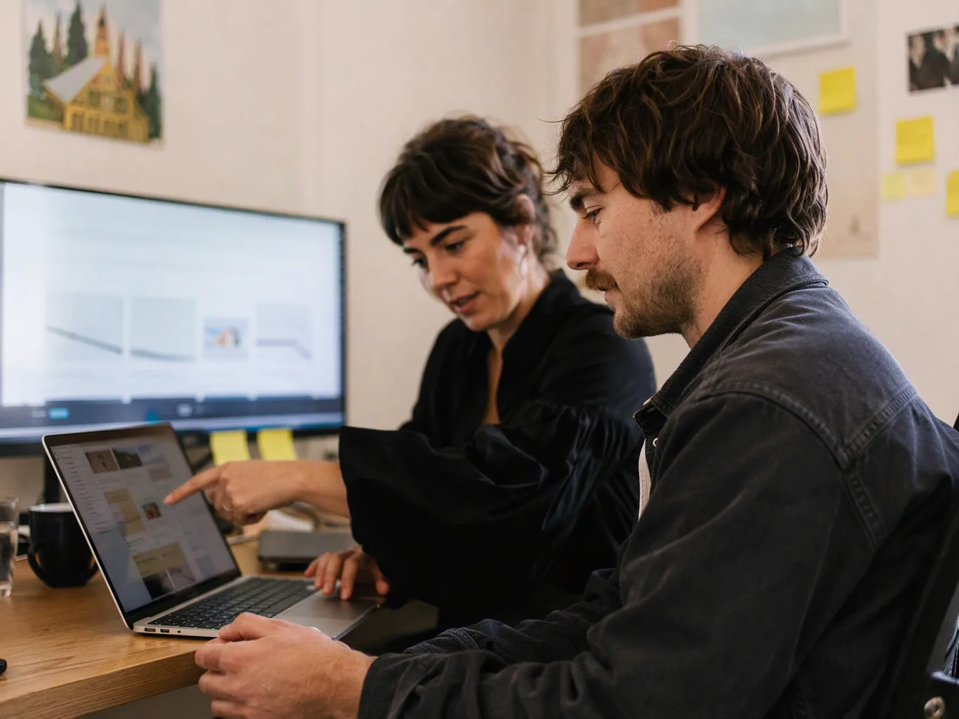 SEO specialist checking site speed reports on a laptop at a desk